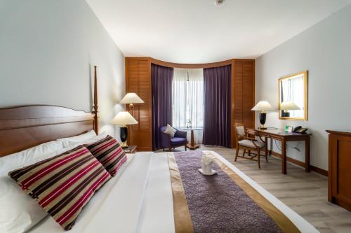 Ένα ή περισσότερα κρεβάτια σε δωμάτιο στο Century Park Hotel