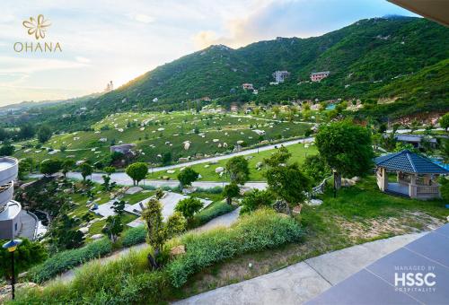 an aerial view of a park with trees and a mountain at Ohana Village in Phương Phi