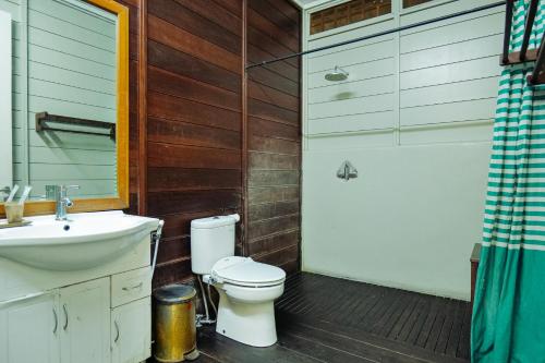 a bathroom with a toilet and a sink and a shower at Villa Marcolina 57 in Gadok 1