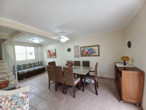 a living room with a table and chairs and a couch at Sobrado 3 Brejatuba in Guaratuba