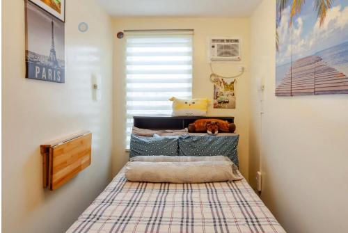 a small bedroom with a bed in a room at Pandora's Nest in Manila