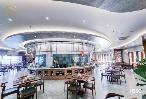 a dining room with tables and chairs in a restaurant at Ohana Village in Phương Phi
