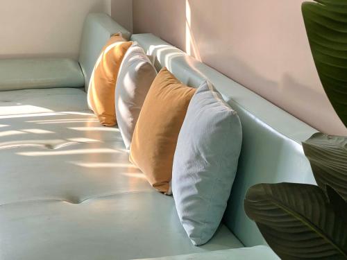 a row of pillows sitting on a couch at Cat Ba Seoul 2 Hotel & Apartment in Cat Ba