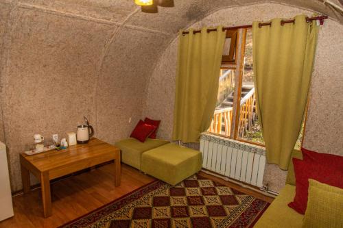 a room with a couch and a table and a window at Supara Chunkurchak in Alamedin