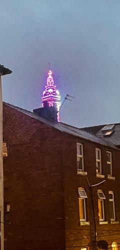 a building with a lit up tower on top of it at Double Room with Private Bathroom Partial Tower view 16 Havelock Street - 5 in Blackpool