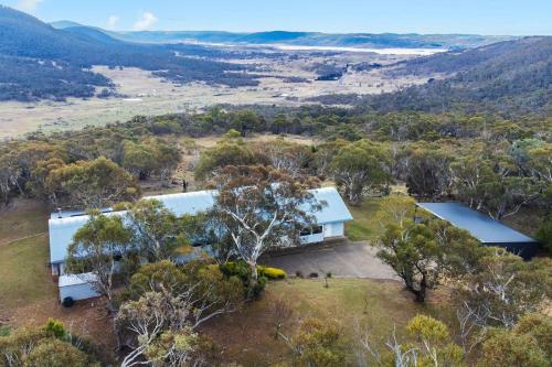 an aerial view of a house with a blue roof at Silvertop Apartment in Crackenback