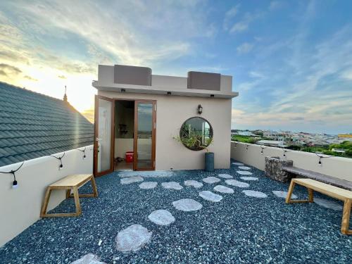 a house with a balcony with two benches on it at Homestay Lucie đảo Phú Quý in Cu Lao Thu