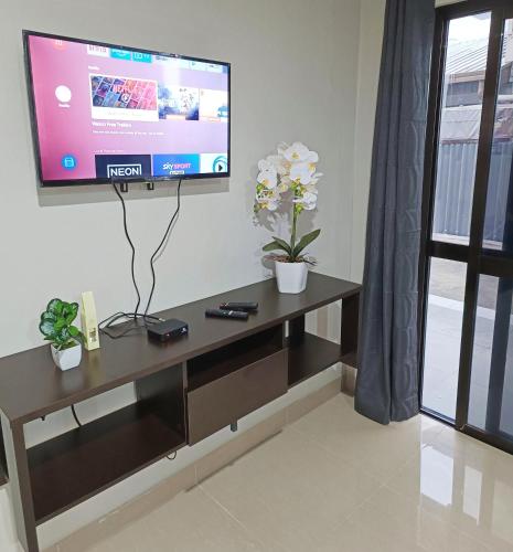 a living room with a tv on a wall at Pacific Apartments Nadi in Nadi