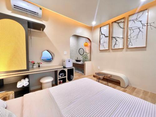 a bedroom with a white bed and two windows at Homestay Lucie đảo Phú Quý in Cu Lao Thu