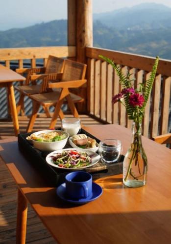 a tray of food on a table on a deck at The Well House in Jiayi