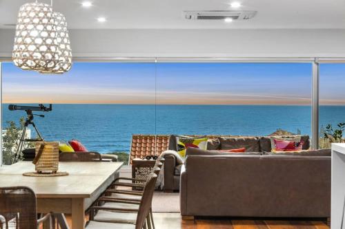 a living room with a view of the ocean at Luxury Beach Views on the Terrace sleeps 10 in Ocean Grove