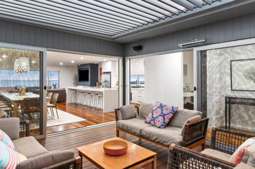 a living room with a couch and a table at Luxury Beach Views on the Terrace sleeps 10 in Ocean Grove