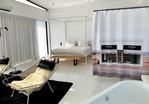 a bedroom with a bed and a bath tub in a room at White Lagoon in Hua Hin