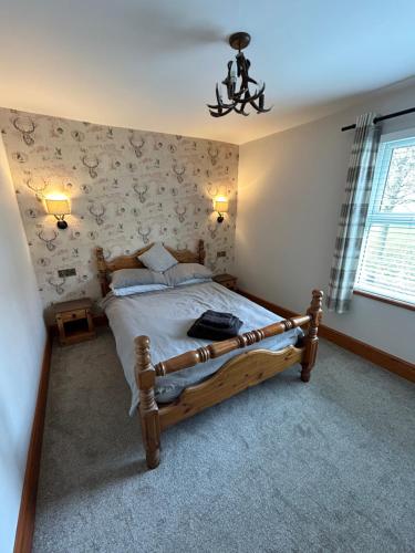 a bedroom with a wooden bed in a room at Cosy Bay Cottage in Scarborough