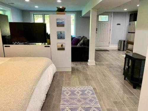 a bedroom with a bed and a living room at The Suite at Pound Ridge in Pound Ridge