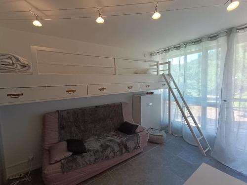 a living room with a bunk bed and a couch at Studio Villard-de-Lans in Villard-de-Lans