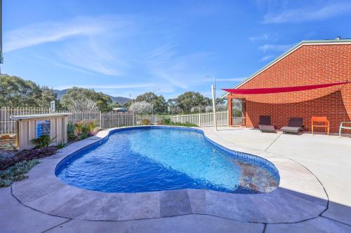 a swimming pool in the backyard of a house at Roseville Motel and Apartments in Tamworth