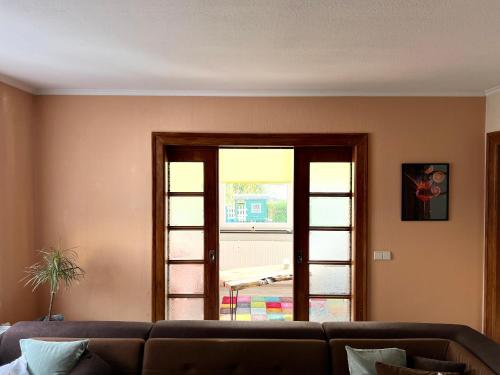 a living room with a couch and a sliding glass door at Sonnige Helene in Thalheim