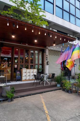 a restaurant with a patio with a table and umbrellas at Rainbow hostel Chiang mai in Chiang Mai