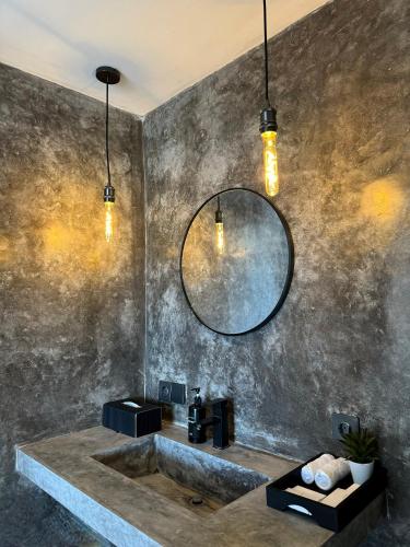 a bathroom with a sink and a mirror at Villa Valeria in Uluwatu