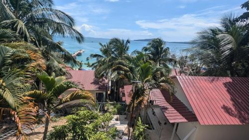 a view of the ocean from a house with palm trees at Skybar Koh Rong in Koh Rong