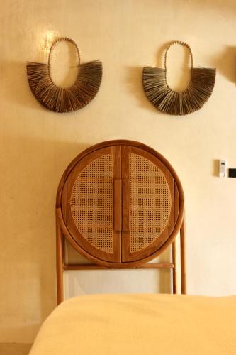 a wooden chair with two mirrors on the wall at Cape Beach Villa Samui in Ban Bang Po
