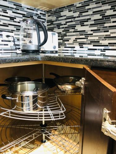 two pots and pans sitting in a dishwasher in a kitchen at Cozy 2 Bedroom Condo with Parking in Calgary