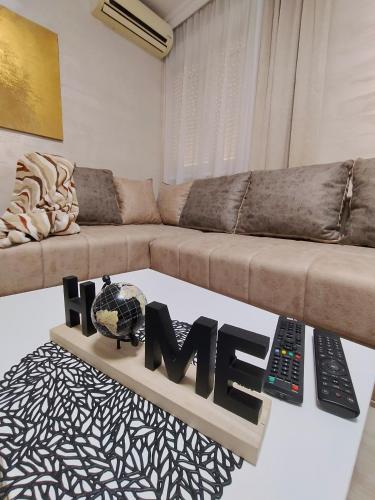a living room with a couch and a word hate on a table at VEMIUR in Čačak