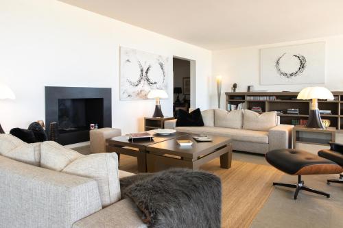 a living room with a couch and a table at La Villa Calvi in Calvi