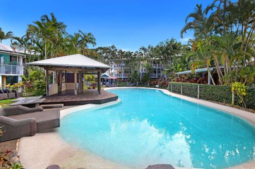a swimming pool with chairs and a gazebo at Noosa Resort & Spa in Noosaville
