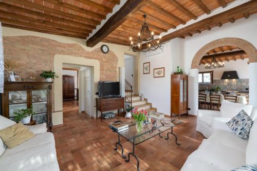 a living room with white couches and a table at La Capanna di Elfo luxury villa View in Siena