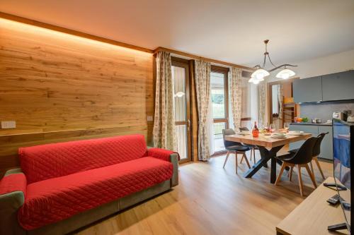 a living room with a red couch and a table at The Lovely Nest - Happy Rentals in Bardonecchia