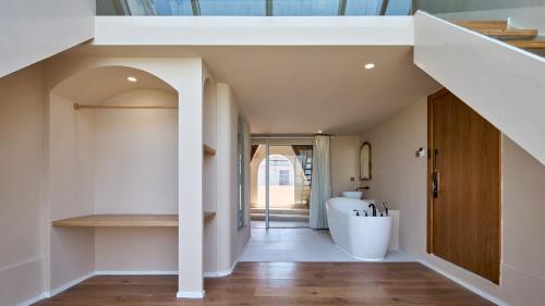 a bathroom with a white tub and a sink at Mila Qi Ting Li Guest House Shanghai in Shanghai