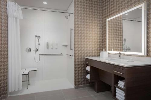 a bathroom with a shower and a sink and a mirror at Home2 Suites By Hilton Laredo North in Laredo