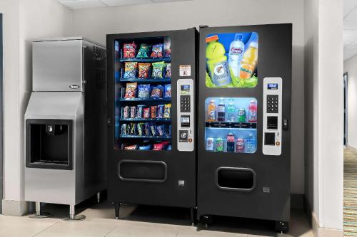 a black vending machine with drinks and drinks at Country Inn & Suites by Radisson, Columbia Airport, SC in Columbia