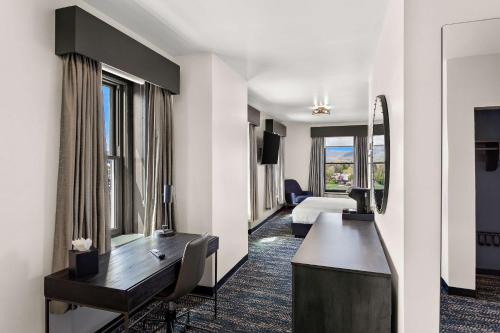 a hotel room with a desk and a bed at Tygart Hotel, an Ascend Collection Hotel in Elkins