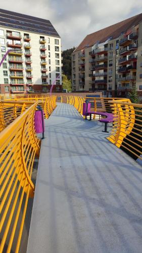 a row of yellow benches on a walkway with buildings at STUDIO JACUZZI BELLE VIEW SINAIA-free parking in Sinaia