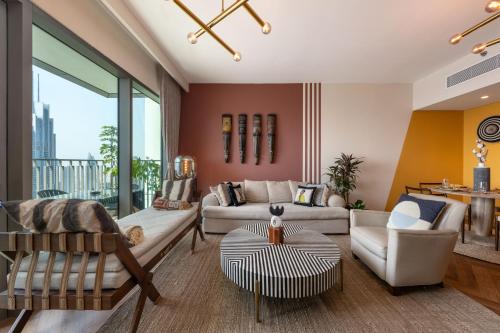 a living room with a couch and a table at Exclusive front row seats to Burj Khalifa fireworks from penthouse level, downtown Dubai in Dubai