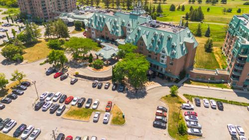 an aerial view of a parking lot with cars at Chateau Cartier Hotel & Resort, an Ascend Collection Resort in Gatineau