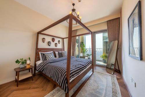 a bedroom with a canopy bed and a balcony at Exclusive front row seats to Burj Khalifa fireworks from penthouse level, downtown Dubai in Dubai