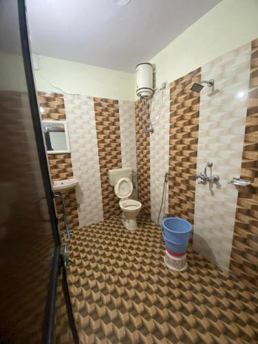 a bathroom with a toilet and a sink and a shower at New Hotel Blue Moon in Jaipur