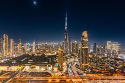 a view of a city at night with traffic at Exclusive front row seats to Burj Khalifa fireworks from penthouse level, downtown Dubai in Dubai