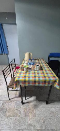 a table with a plaid table cloth on it at อารมย์ดี อพาทเม้นท์ ขอนแก่น in Ban Nong Waeng