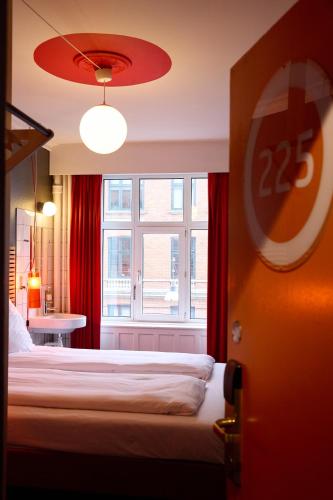 a hotel room with a bed and a window at Annex Copenhagen in Copenhagen