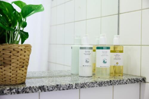 a shelf with four bottles of essential oils on it at Annex Copenhagen in Copenhagen