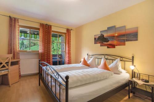 a bedroom with a bed and a window at Ferienwohnung Alpenrose in Bad Reichenhall