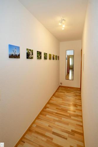 a hallway of a room with paintings on the wall at FeWo „Im Tal der roten Traube“ in Bad Neuenahr-Ahrweiler