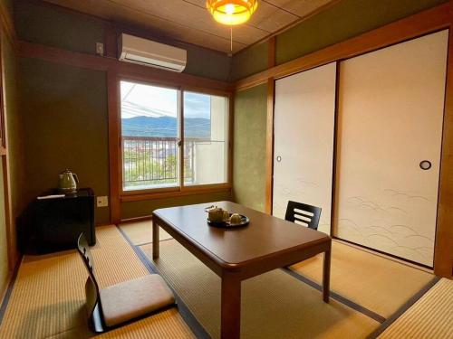 a living room with a table and a window at Only One Group! Koyasan 35min by Car, 2h by Train, Free Bikes, Walk to Station in Katsuragi