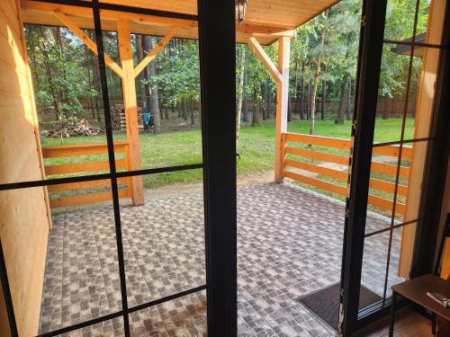 an open door to a screened in porch at Leśna Osada Wieliszew in Wieliszew