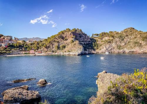 a view of a body of water with rocks at Bellavista apartment Letojanni in Letojanni
